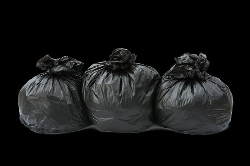 Waste removal trucks navigating Shadwell streets